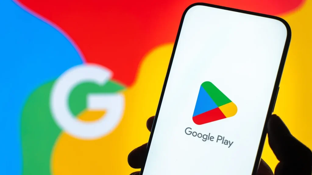 Sklep Play – co to jest i jak bezpiecznie pobierać aplikacje na Androida? Sklep Google Play na ekranie smartfona z logo Google w tle
