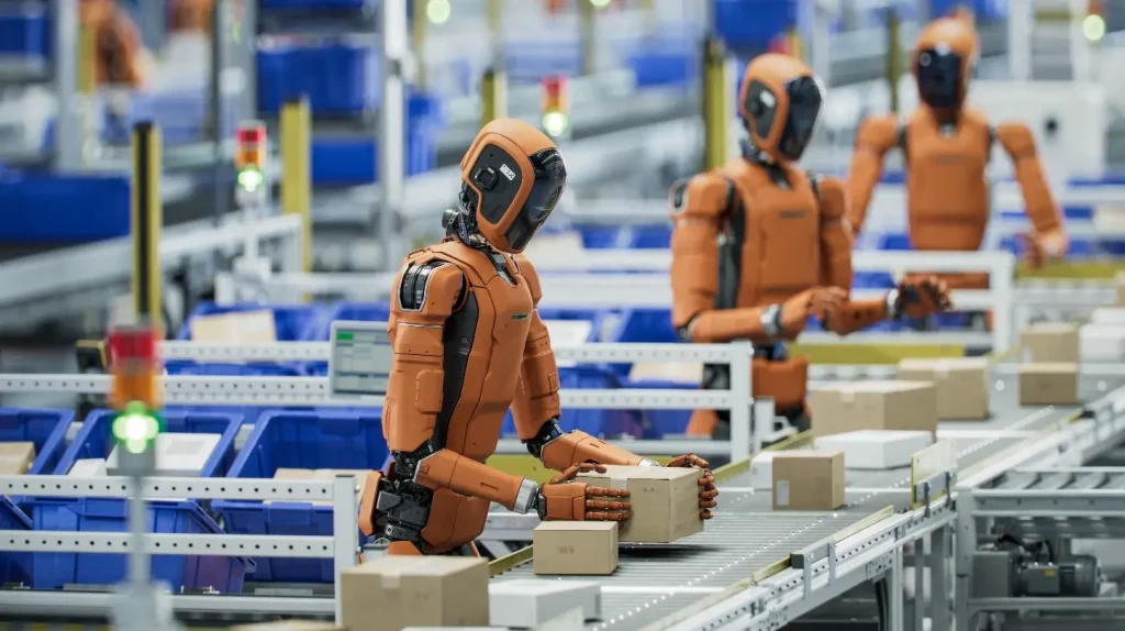 Anthropic policzył, ile pracy potrafią już wykonać roboty. Wynik robi wrażenie Roboty humanoidalne pracujące przy taśmie produkcyjnej i przenoszące paczki w magazynie. Źródło: Shutterstock.